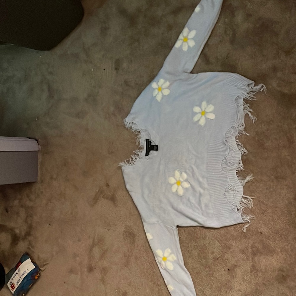 has hanging threads from the V-neck and the bottom that’s just how it’s made